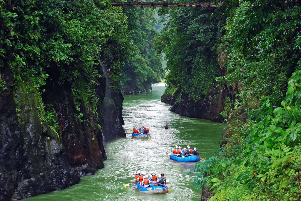 Boats rafting down a river in Pacure in Costa Rica